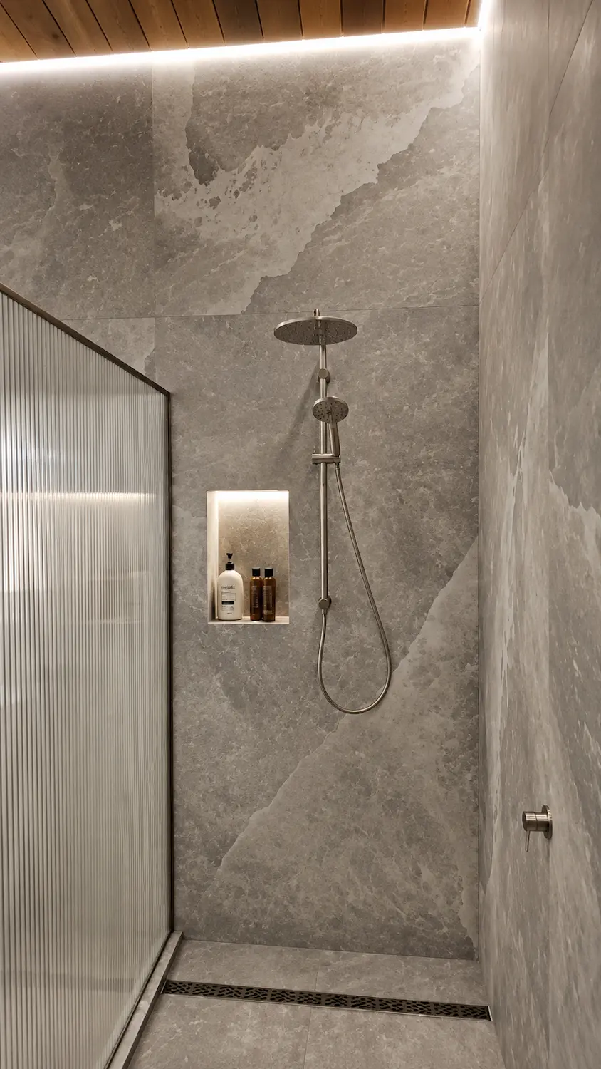 XL sheet format porcelain shower wall with continuous stone-look finish