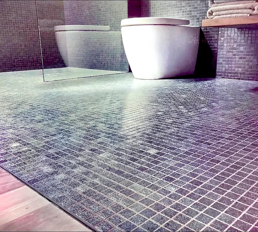 Small-format mosaic floor plane with clean edge control