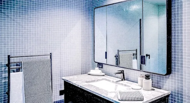 Glass mosaic vanity splashback with controlled alignment and clean edge finish