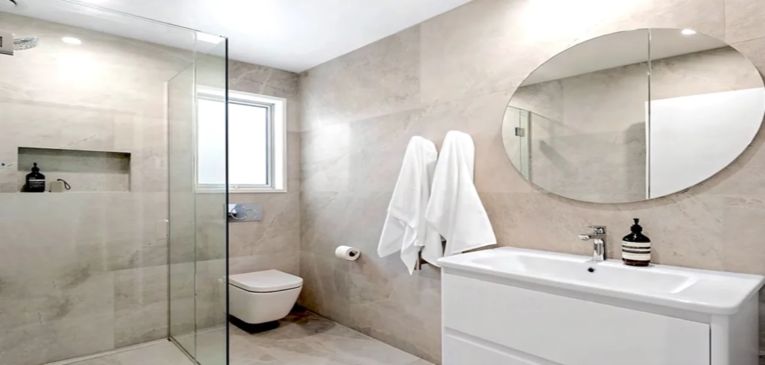 Large-format stone vanity and shower