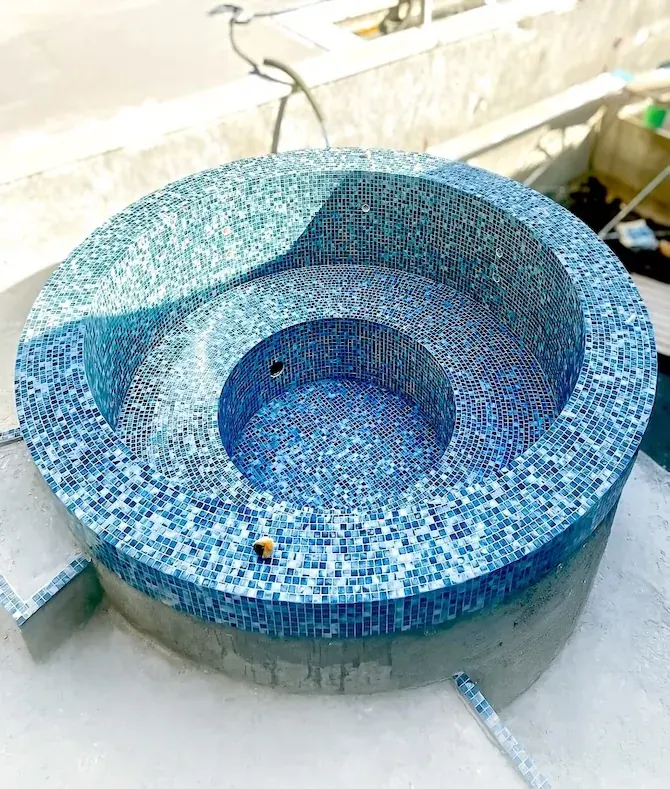 Spanish glass mosaic spa with circular pool geometry