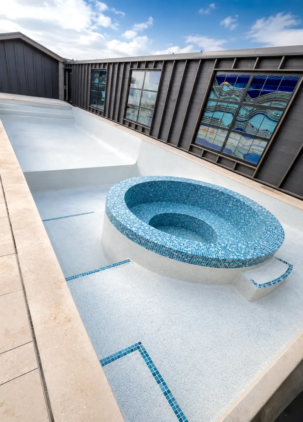 Spanish mosaic spa presented as an architectural feature within the main pool