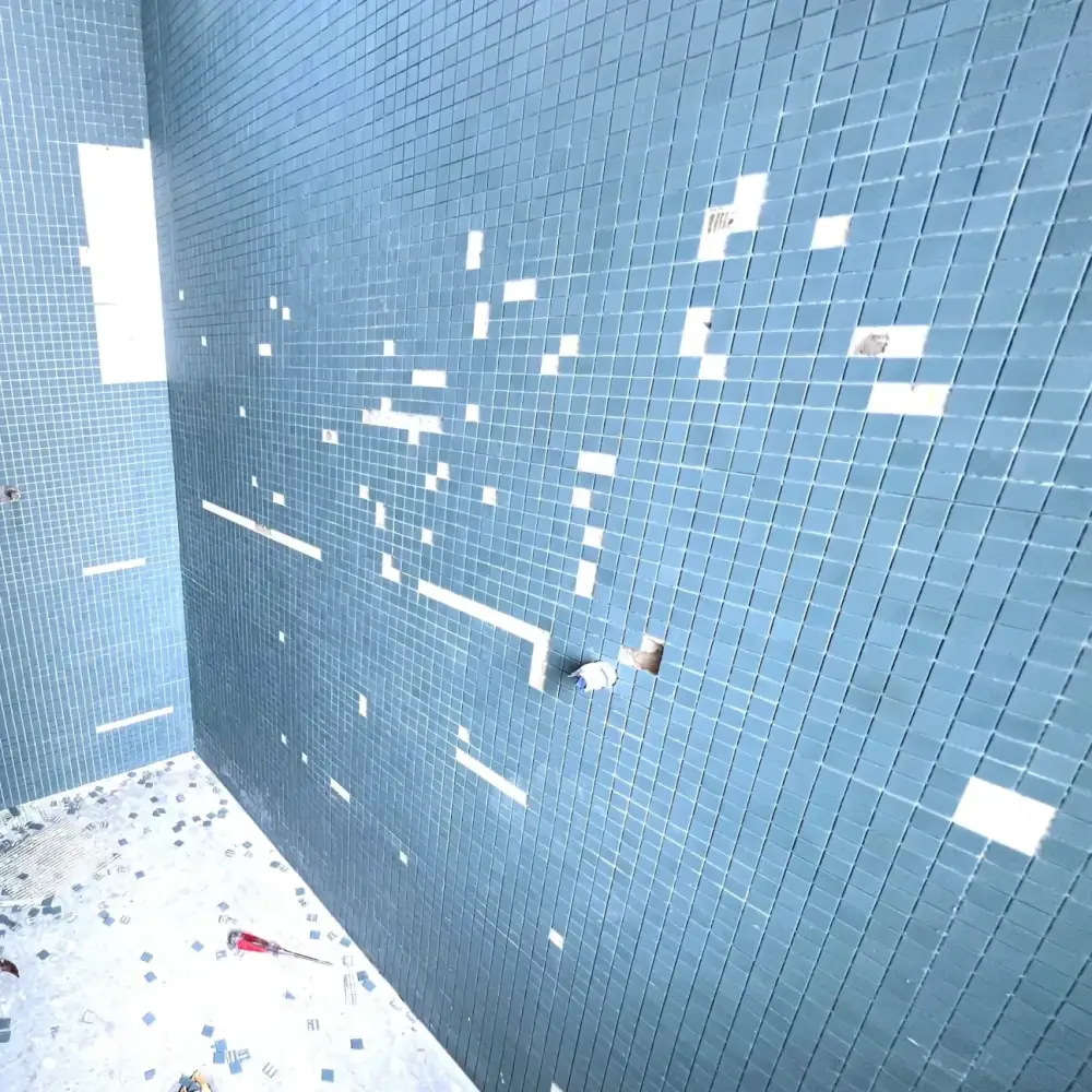Precision mosaic bisazza tile layout installation within bathhouse environment.