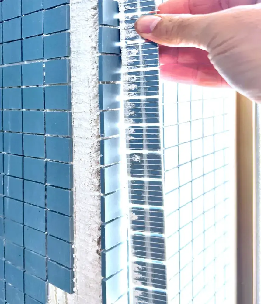 Mosaic bathhouse detail with precise mitred edge work.